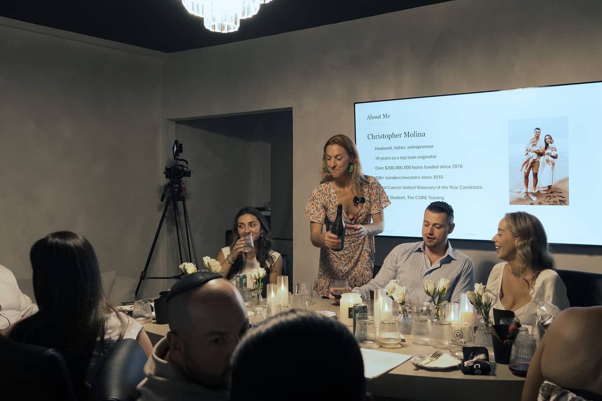 Christopher Molina presenting at a candlelit Lunch & Learn dinner