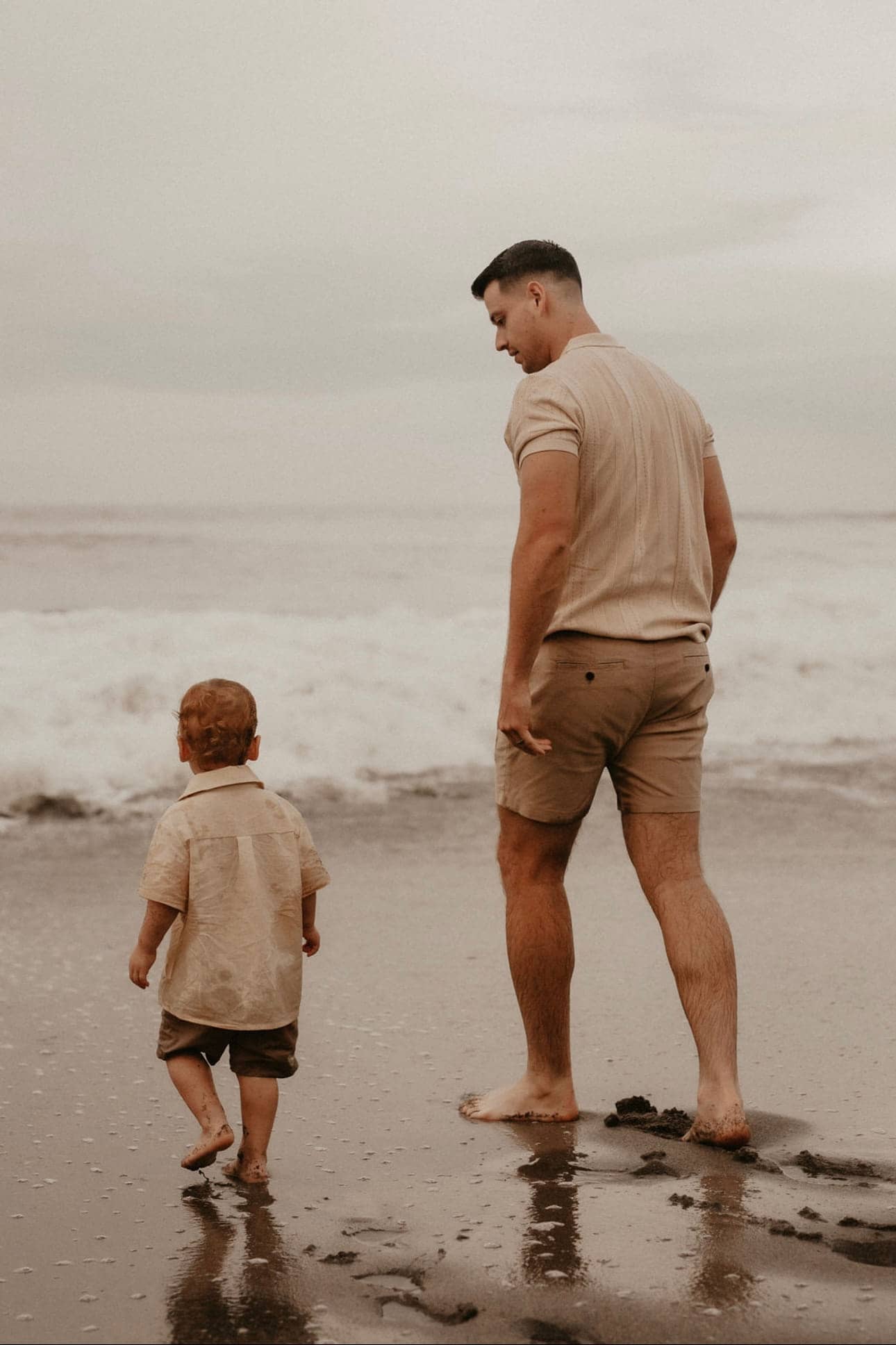 Christopher Molina walking the shoreline with his son